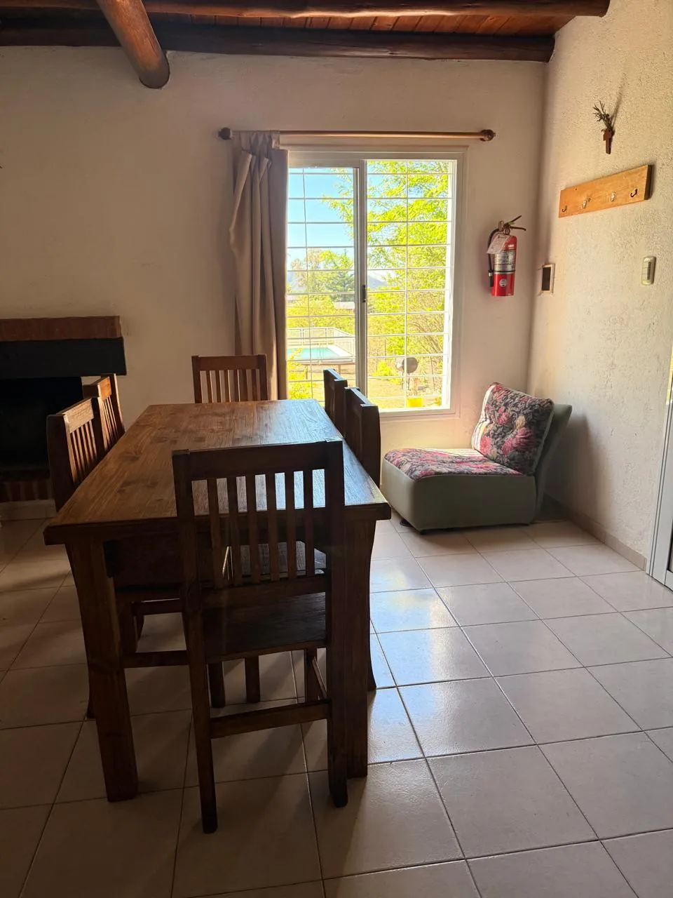 Comedor con mesa de madera y ventanal